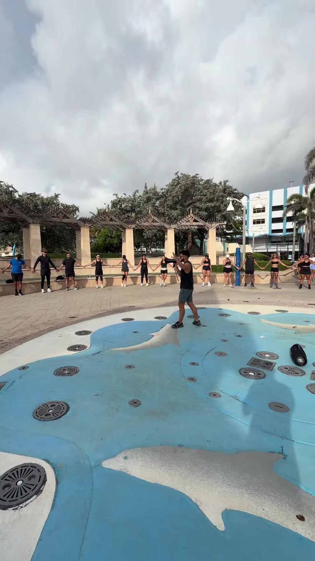 The club circling up at the plaza before the run